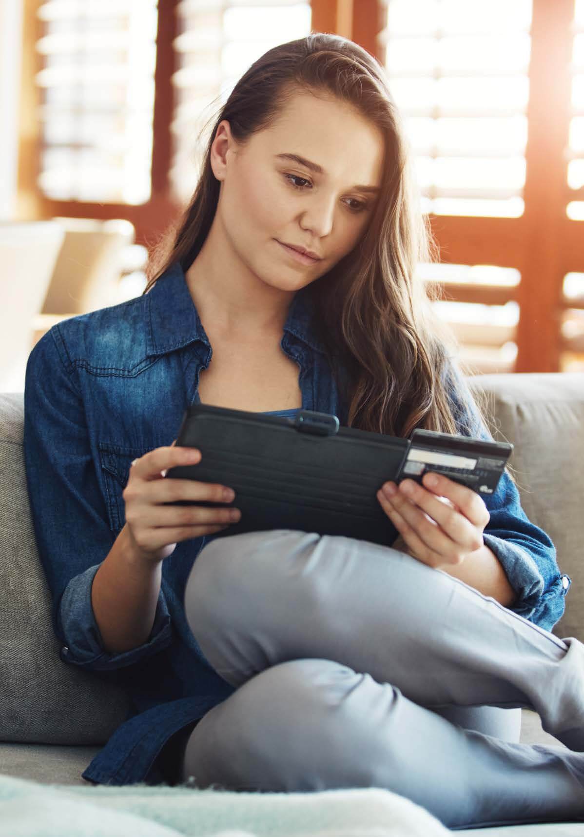 Woman-On-Couch-Using-Tablet-and-Credit-Card